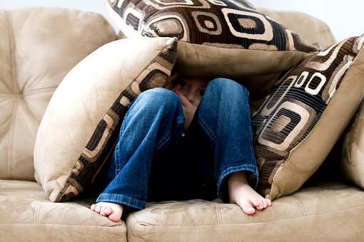 Child anxiously hiding to avoid going to school