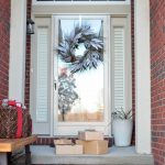 Pile of gifts in front of a door.