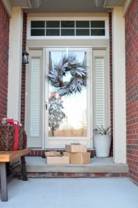 Pile of gifts in front of a door.