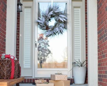 Pile of gifts in front of a door.