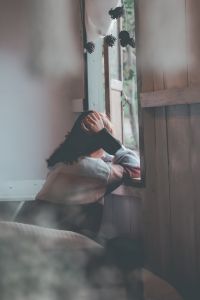 picture of a woman leaning looking out of a window