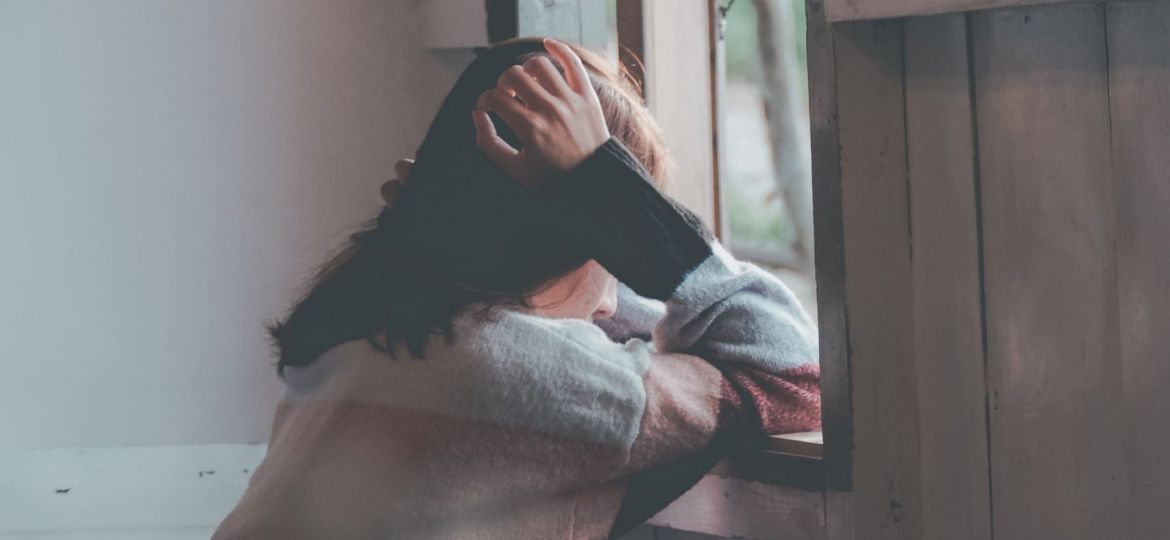 picture of a woman leaning looking out of a window
